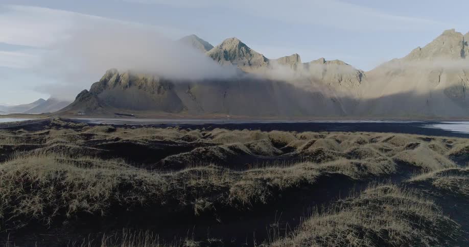 Clouds float around mountains