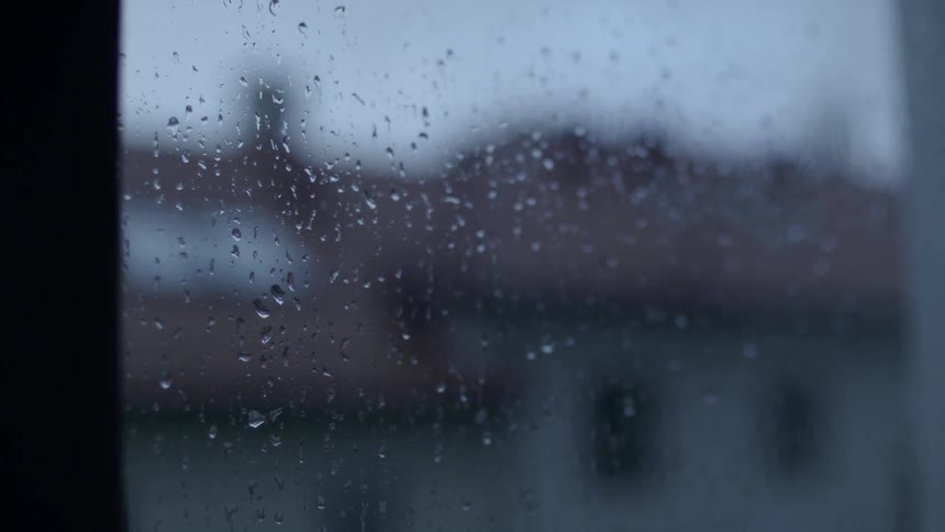 Rain falls on the window