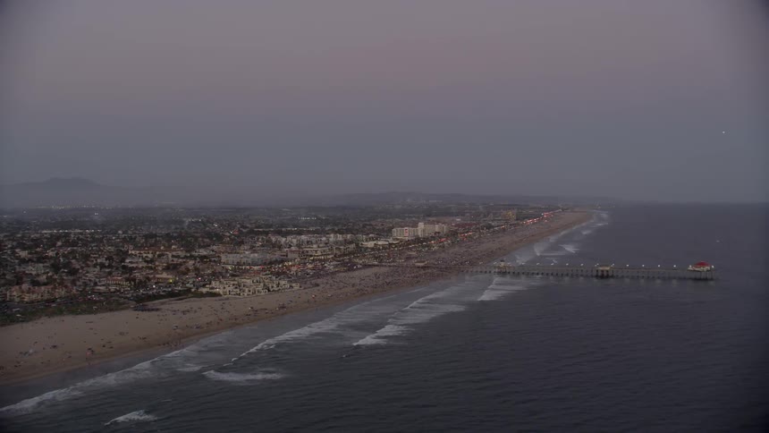 Ocean waves flow towards the shoreline at sunset