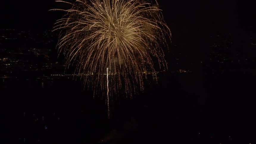 Aerial view of massive Fireworks Display over the ocean, 4th of July