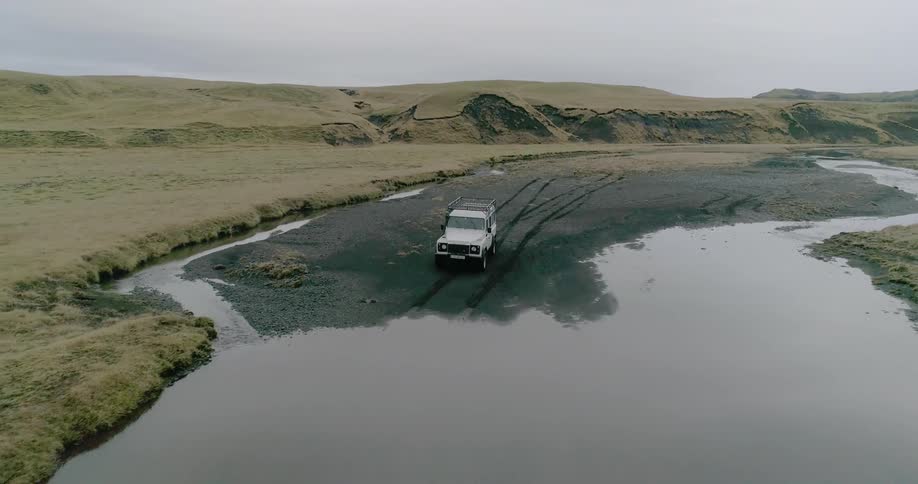 The truck rides over the muddy wet area