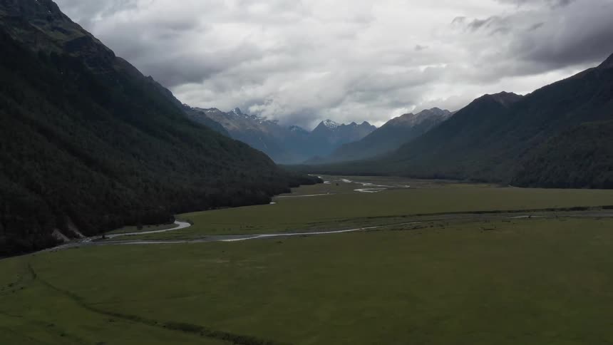 The fields are green with water moving around the mountains