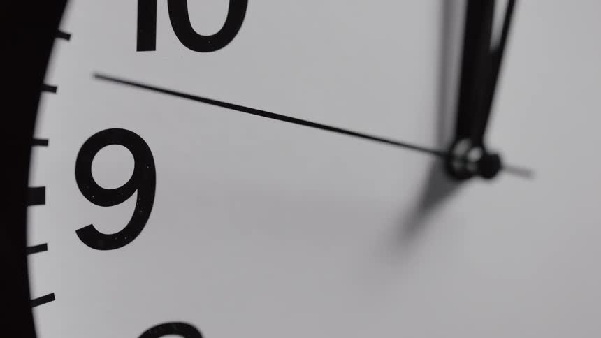 Seconds tick by on a wall clock