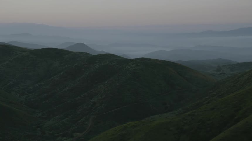 Rolling hills and peaks at sunset