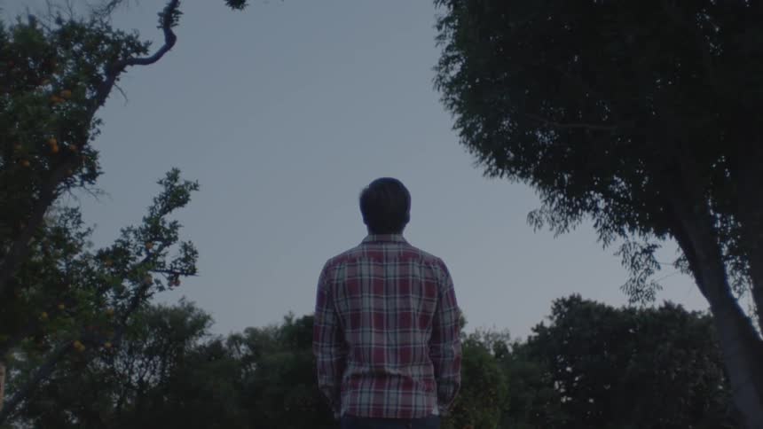 A man walks through his yard