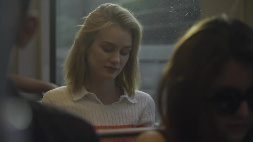 A woman is riding the train at night