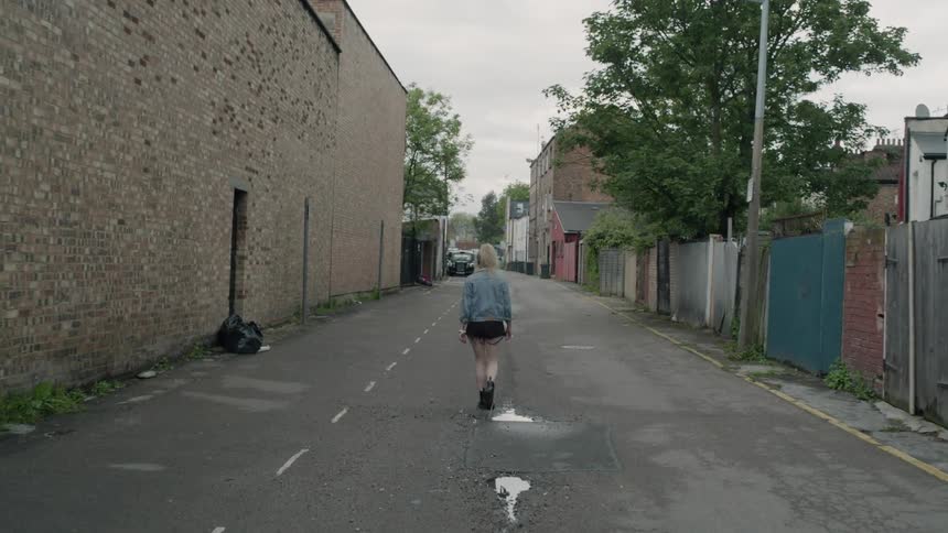 A woman walks on a city street