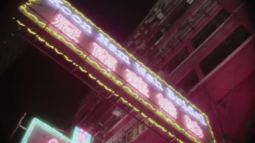 Neon signs illuminate buildings in an asian country at night