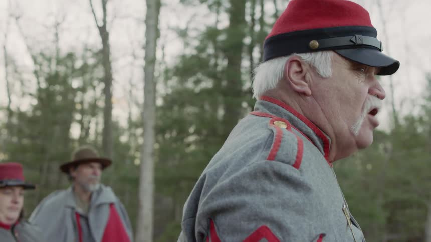 A man in a military outfit is giving a speech