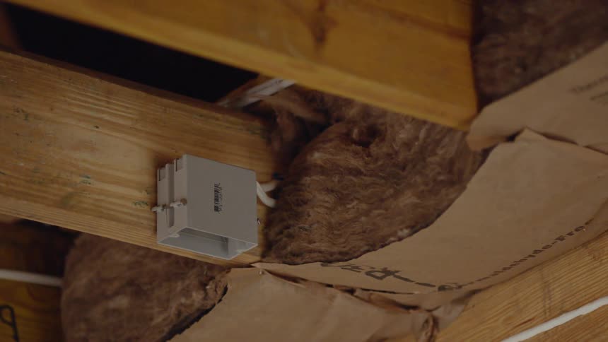 Wires run along the insulation of the home