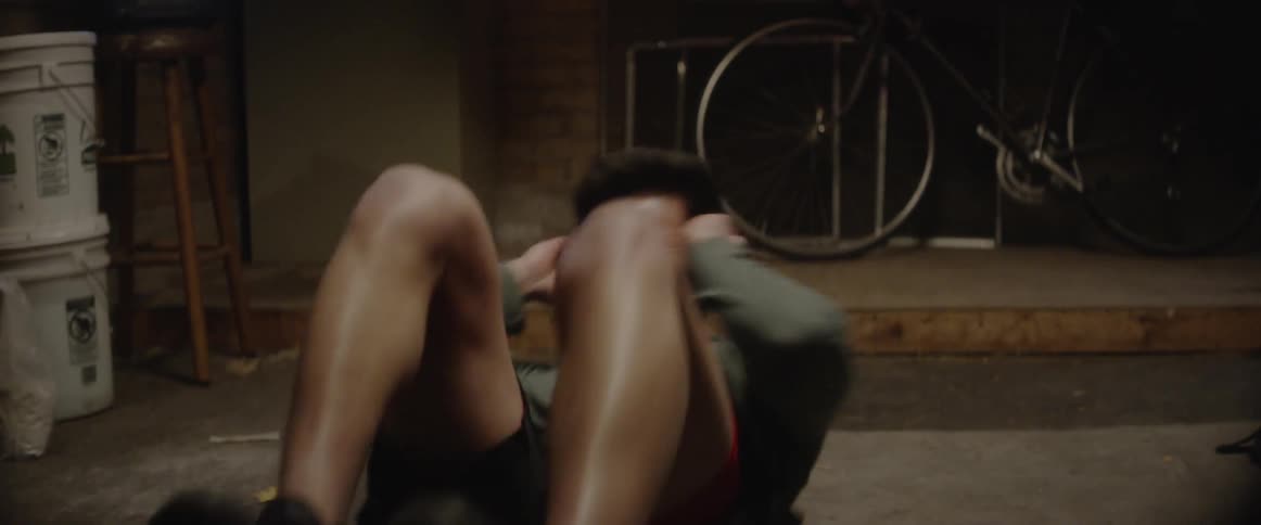 Man does bicycle ab exercises on the floor