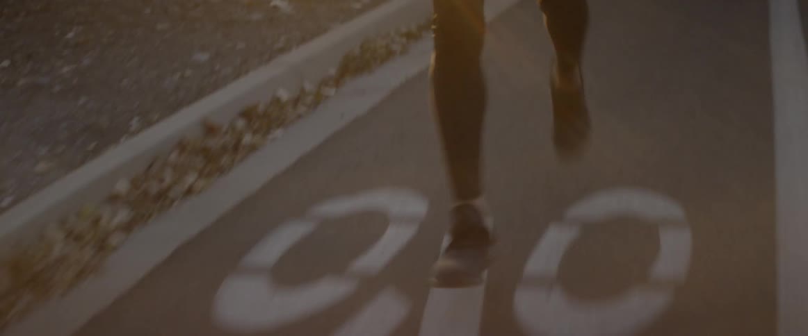 The person is running down the bike lane in the road