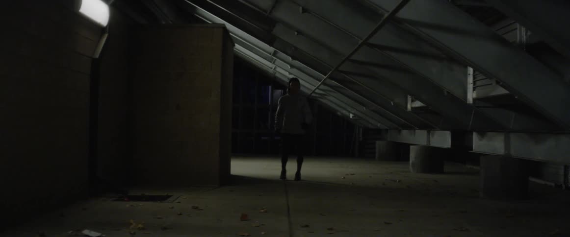 Man in hoodie does warm-up exercises
