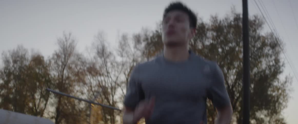 Man jogs outside at sunset