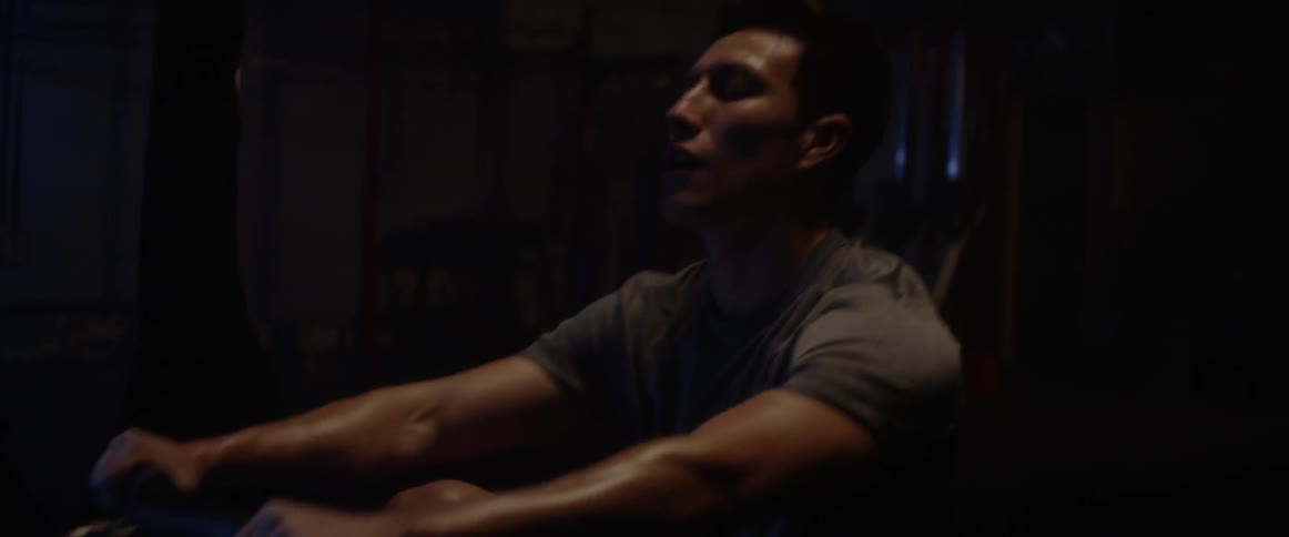 A man exercises on a rowing machine