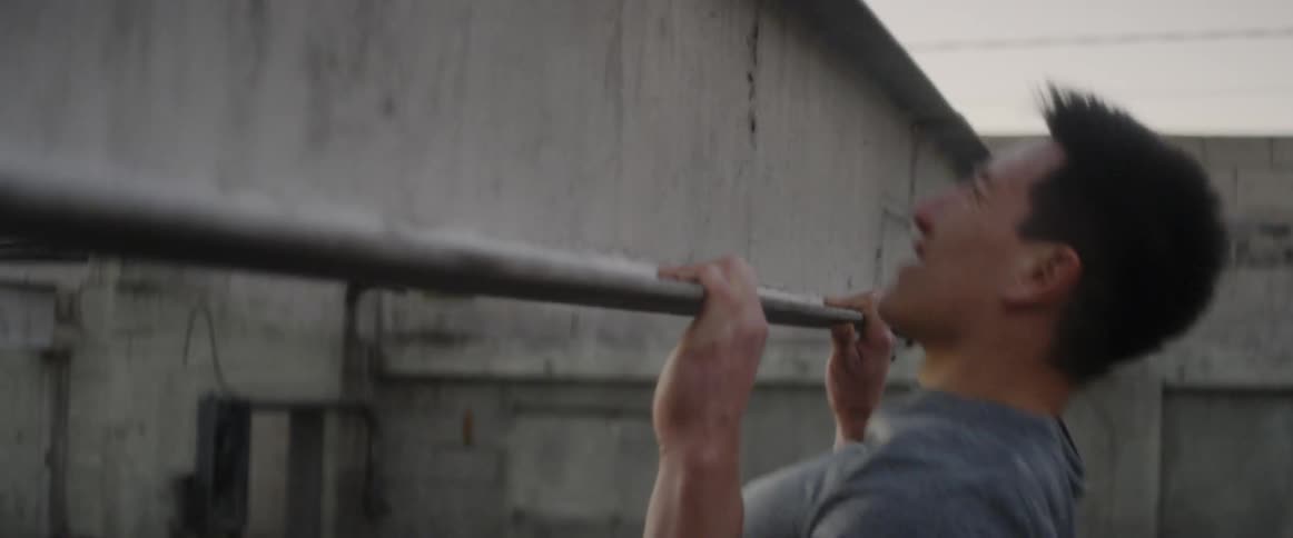 Man does pull ups using a steel beam
