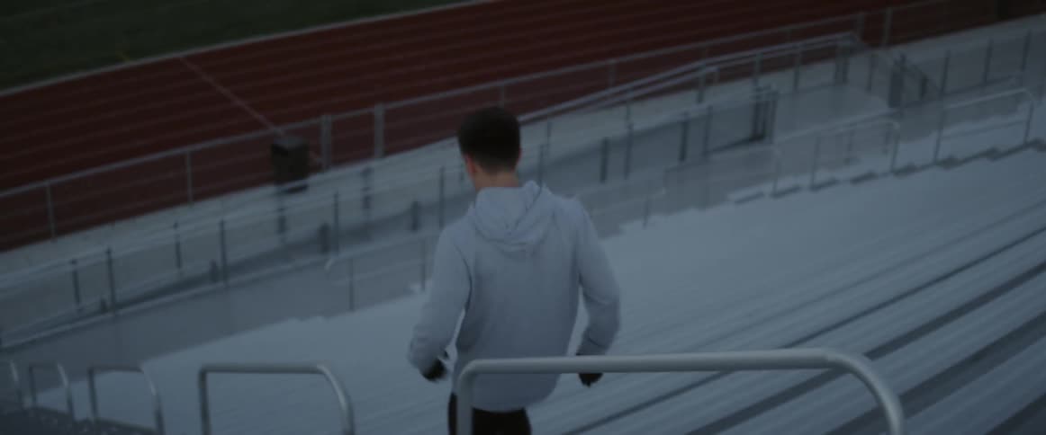 Man jogs down stadium steps