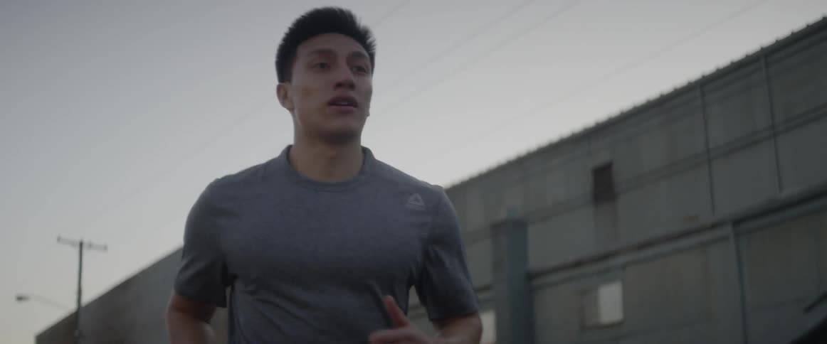 Man jogs outside at sunset