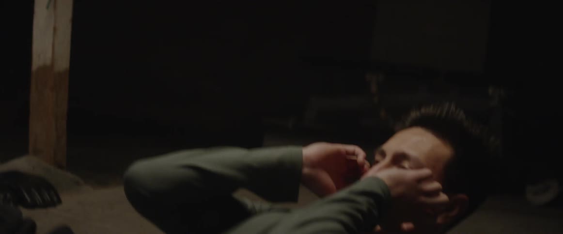A man does crunches on the floor
