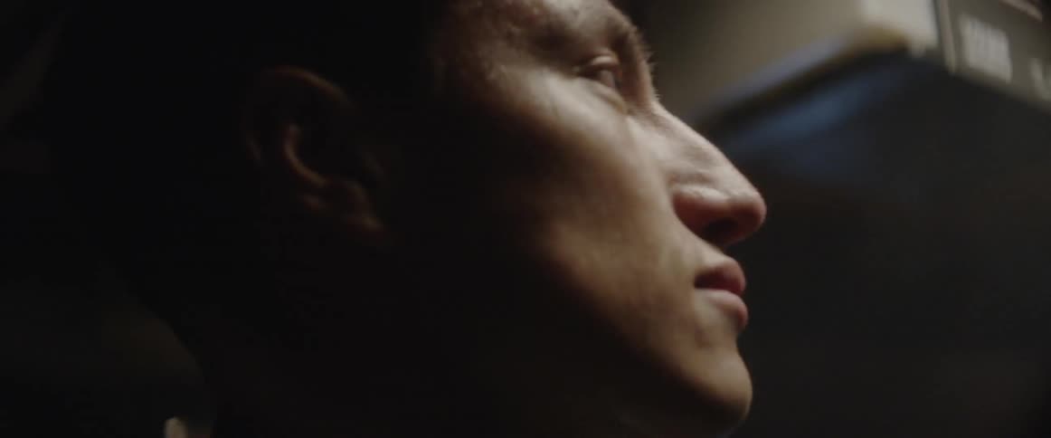 A man slowly shakes his head back and forth stretching