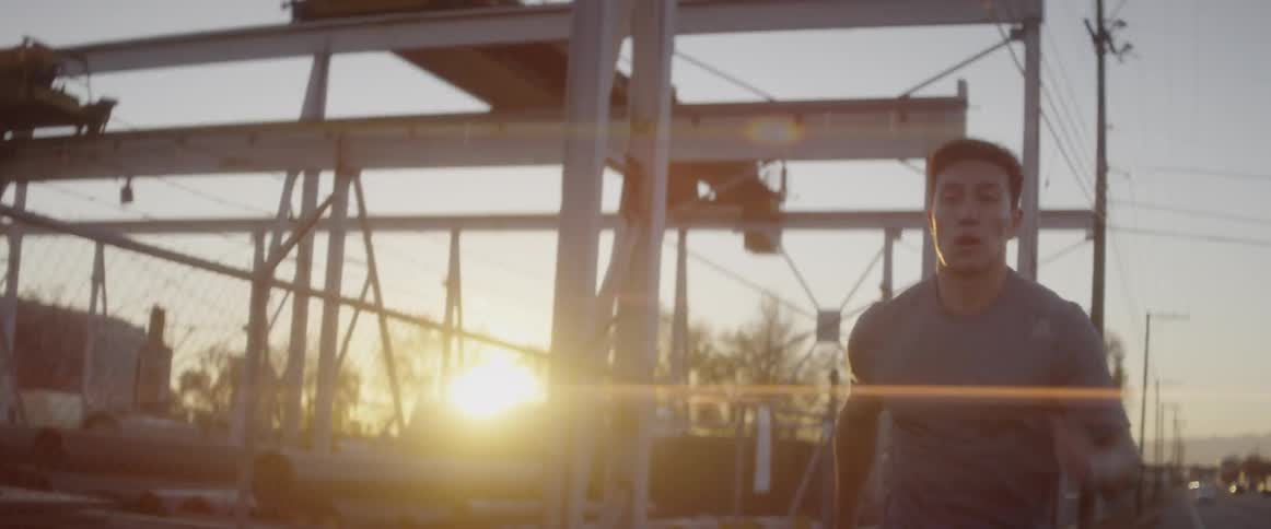 A man is running as the sun rises