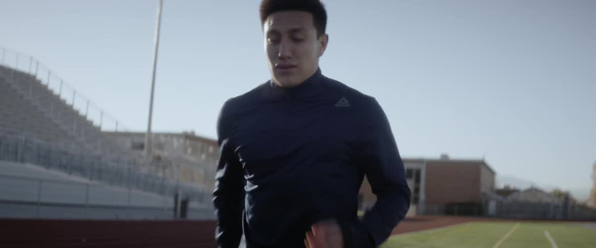 A man jogs in place at a track