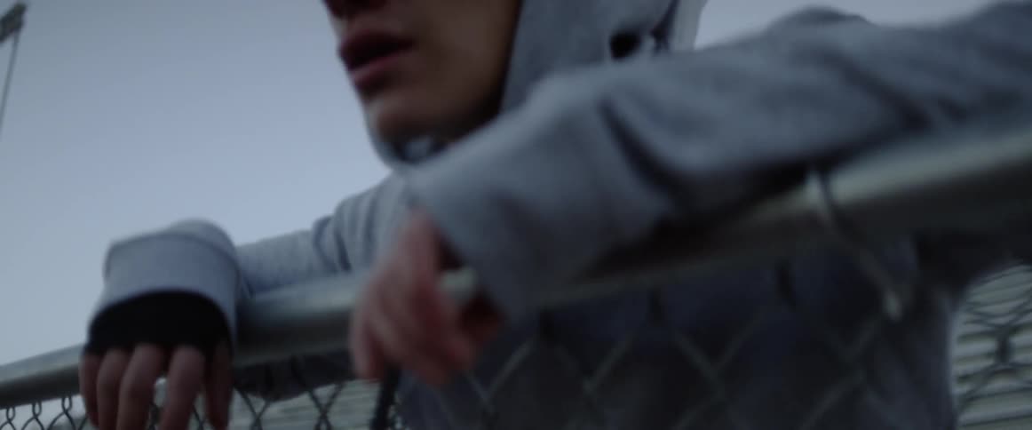 Man exercises on outdoor bleachers