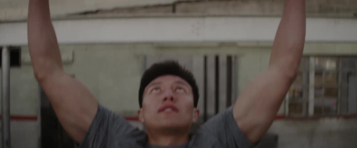 A man does pull ups on a concrete beam