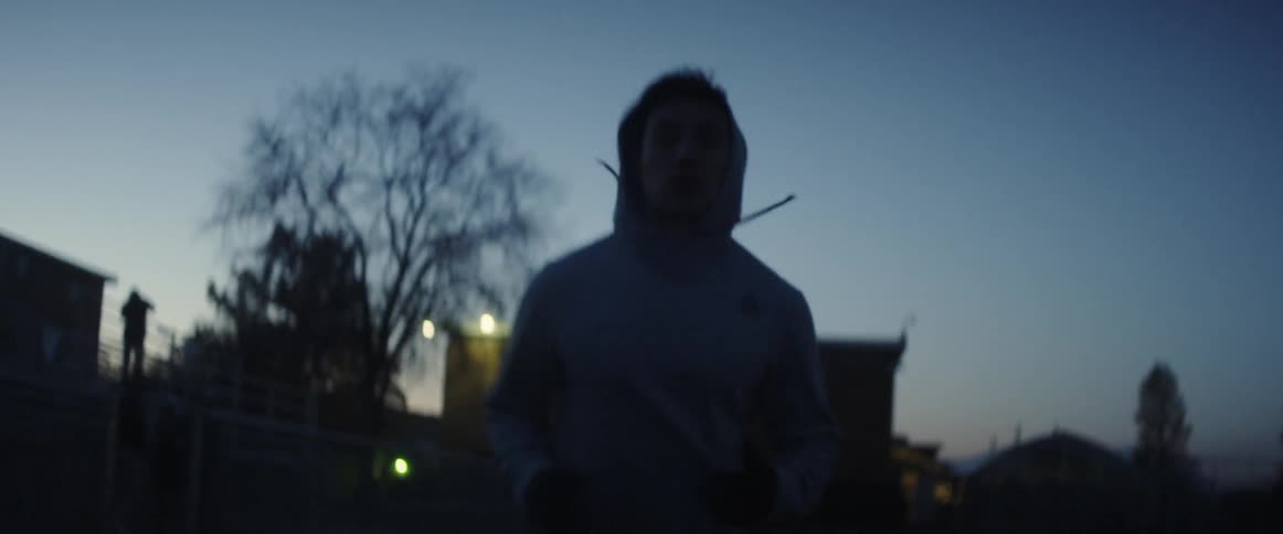 A man is jogging outside at sunset