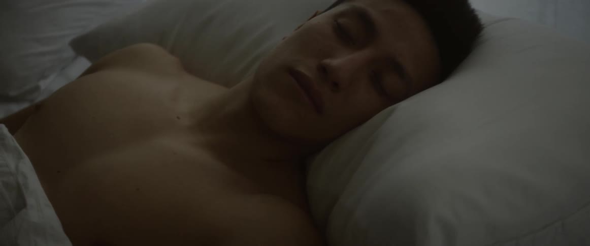 Shirtless man sleeps in bed