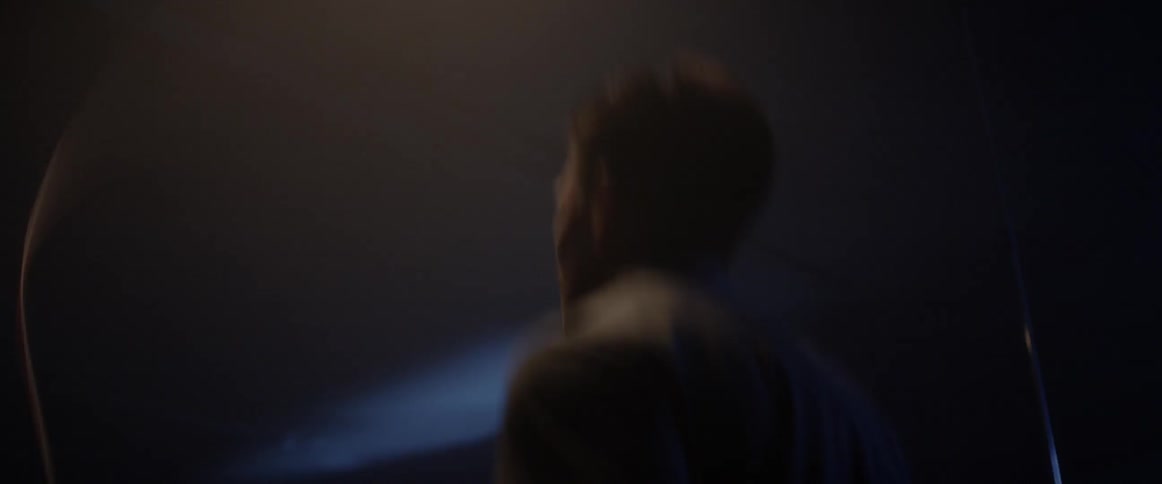 A man jumps up and down in the dark room