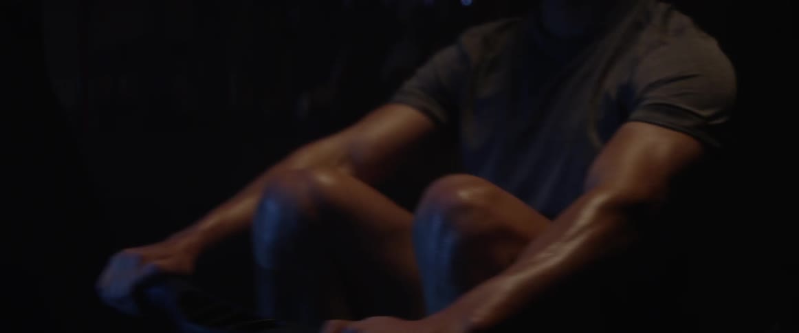 A man exercises on a row machine