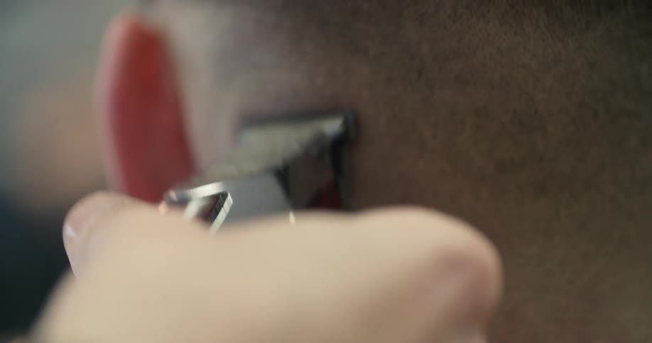 A man is getting a close cut