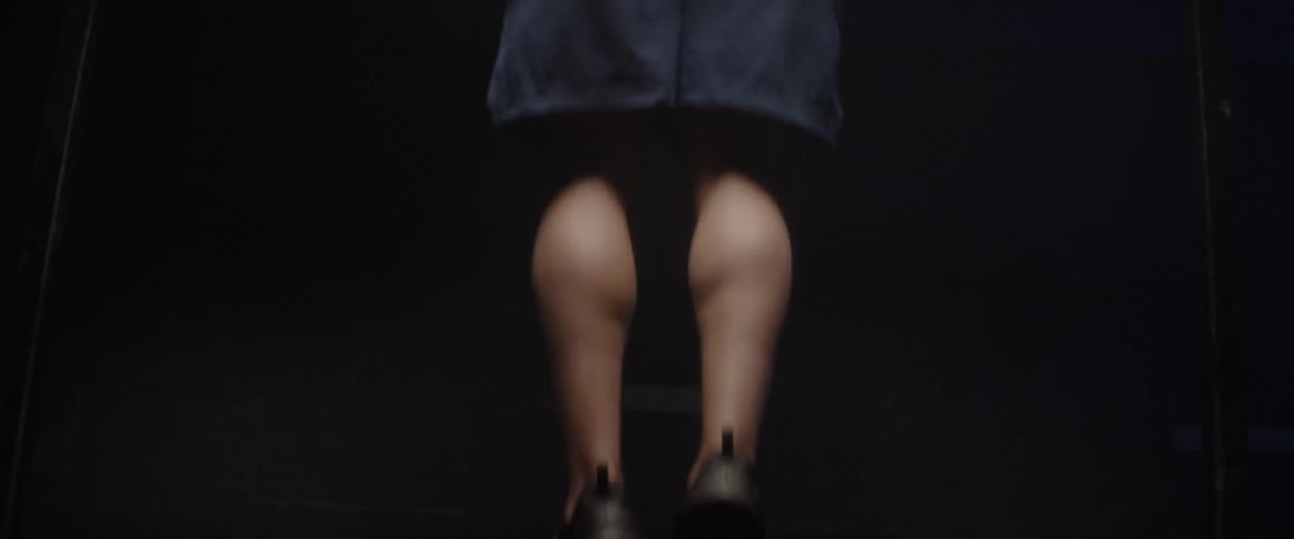 A man does pull ups in the dark room