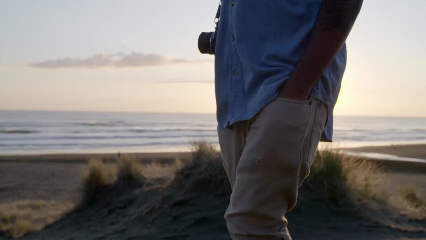 A man is walking on the beach