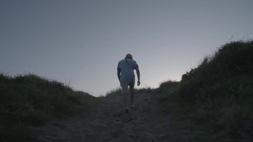 Man walking up a steep hill