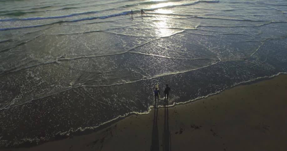 People are running into the water