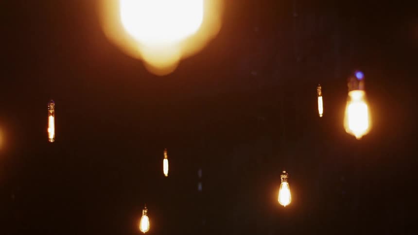 The ceiling has many hanging light bulbs