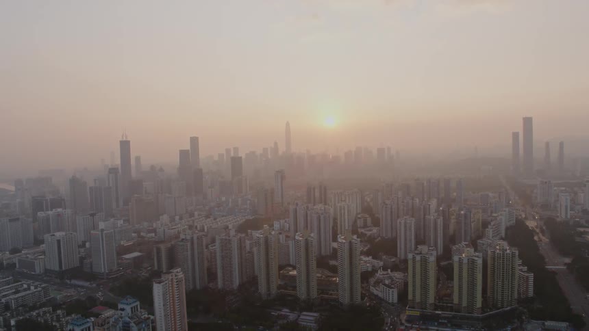 The sun sets over skyscrapers