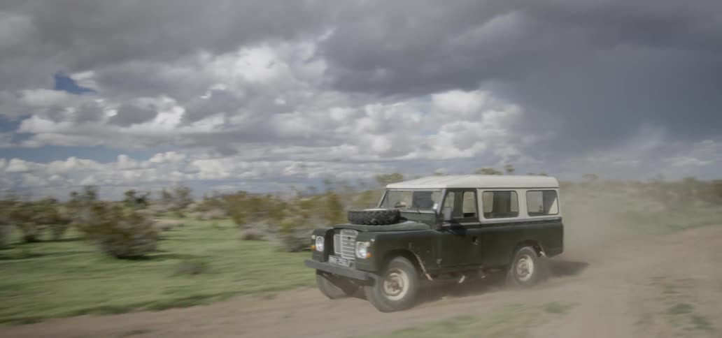 A truck drives on the dirt road