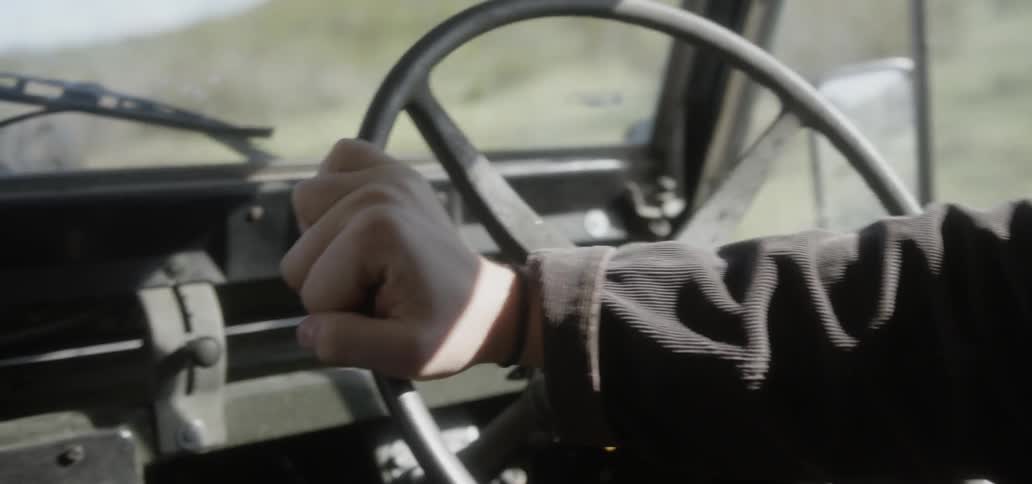 Hand on steering wheel driving