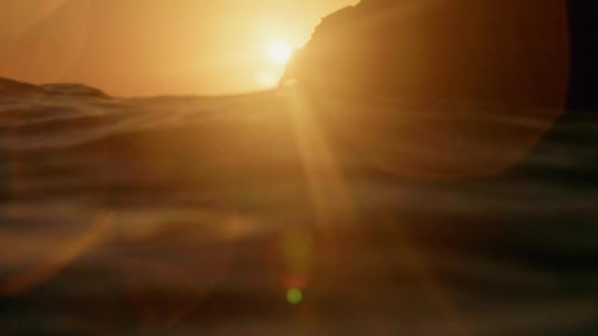 The sun shines on an ocean at sunset