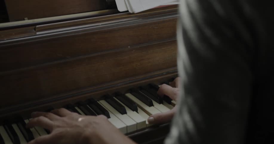 Woman playing a piano in a house