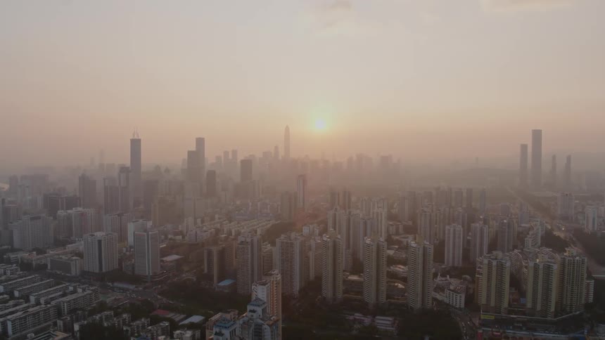 The city is covered with fog at sunset