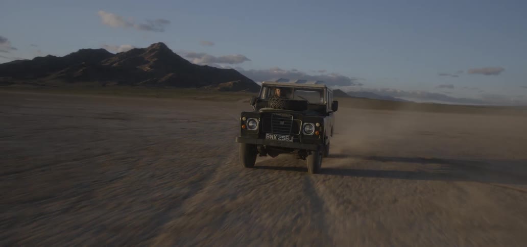 Vehicle drives across dirt field