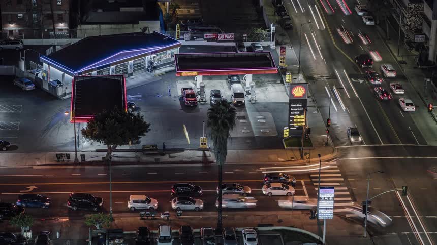 Cars speed through a busy intersection