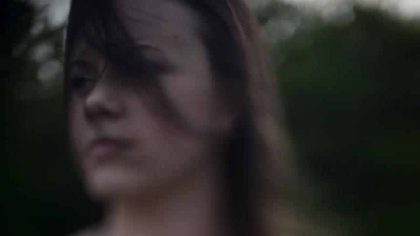 Woman blinks as her hair blows in the wind