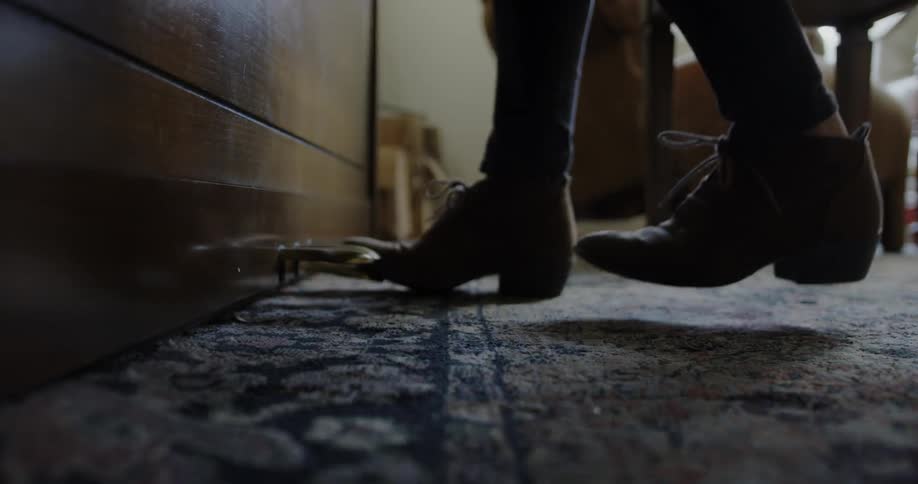 A woman taps her foot at a piano