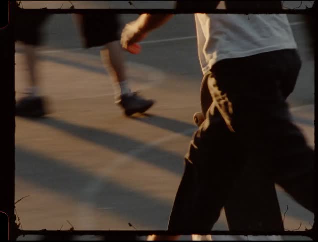 A man skateboards over concrete