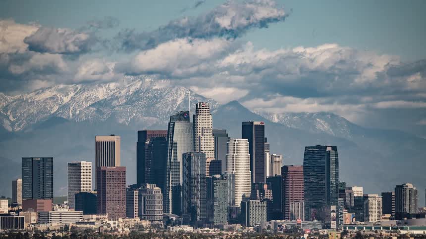 Clouds float over city skyscrapers